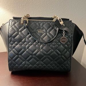 Women’s black Guess quilted handbag.